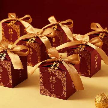 Red & Gold Double Happiness Chinese Wedding Favor Boxes with gold ribbons on a red background