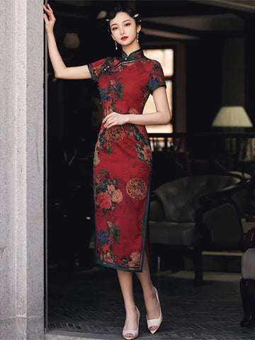 Woman in a Vintage Red Chinese Floral Qi pao Cheongsam Dress standing in a dimly lit room.