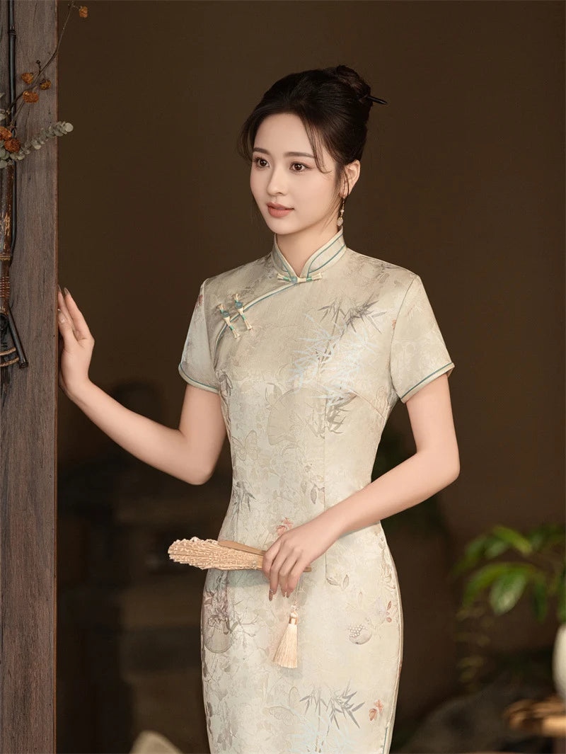Woman in a traditional Beige Vintage Short Sleeve Midi Qipao Dress  holding a fan against a dark background