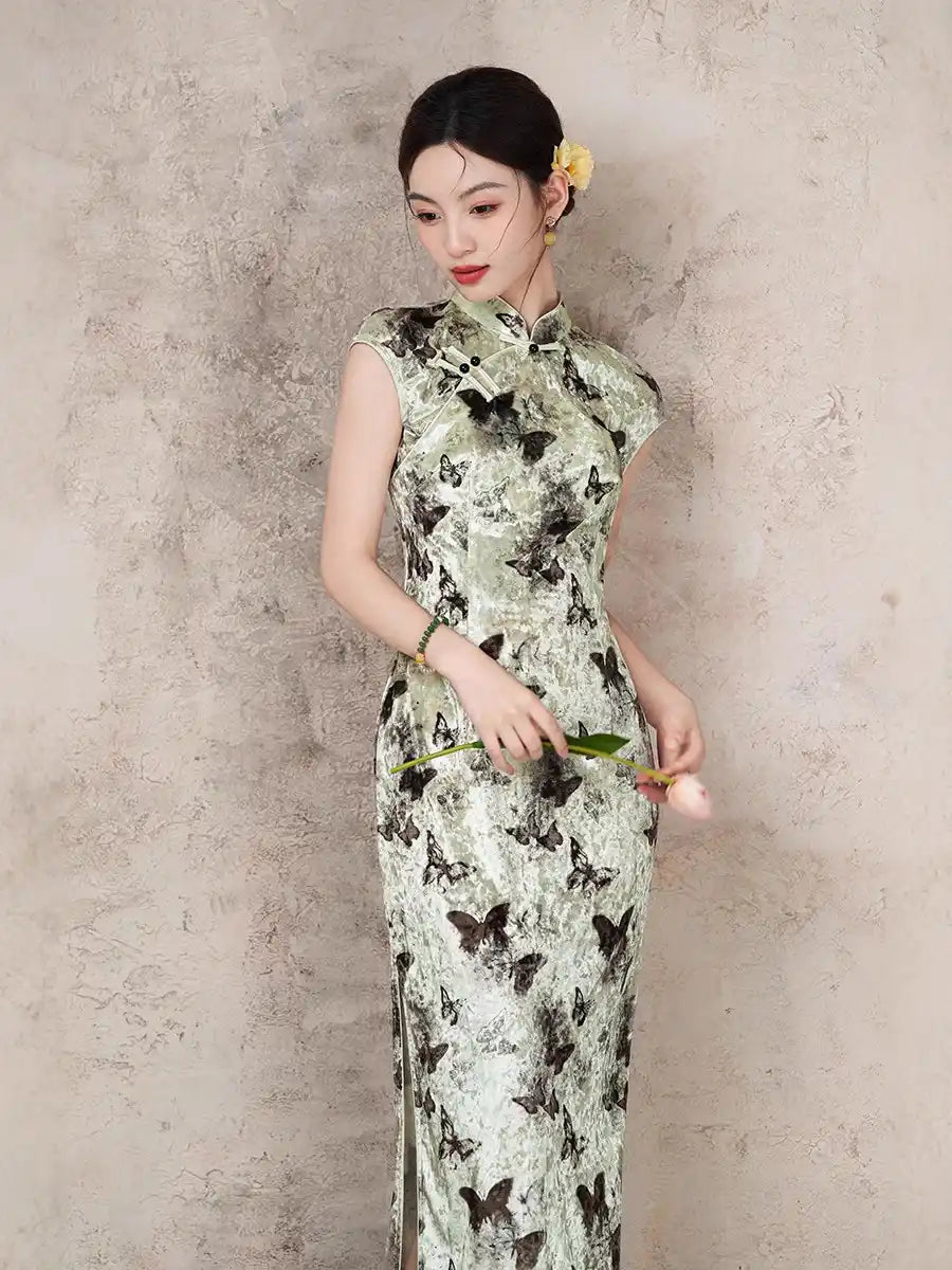 Woman wearing a Elegant Velvet Qipao Dress with Butterfly Print against a textured wall
