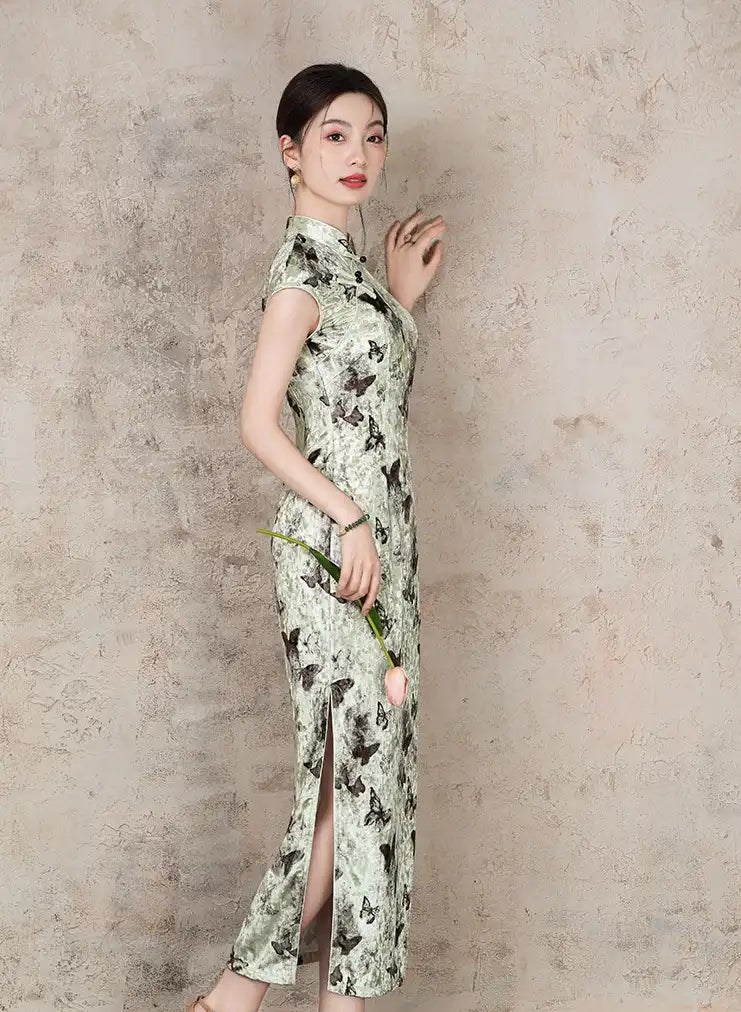 Woman wearing a Elegant Velvet chinese Qipao Dress with Butterfly Print against a plain background