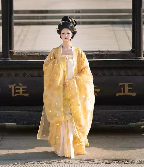 Woman in yellow and Golden Traditional Chinese Tang Dynasty Hanfu Dress Set garment standing in front of a black vehicle with gold characters.