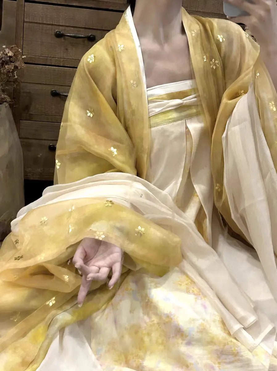 a woman wearing a yellow and Golden Traditional Chinese Tang Dynasty Hanfu Dress Set traditional outfit with floral patterns.