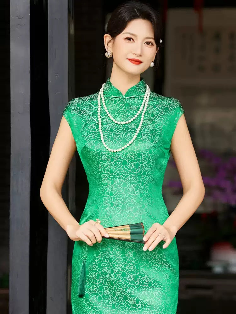 A chinese girl in  sleeveless green  silk qipao dress
