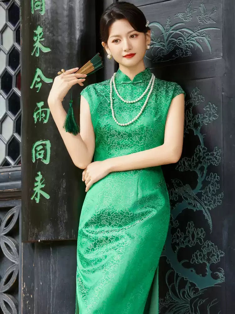 A chinese girl in green sleeveless silk  qipao dress