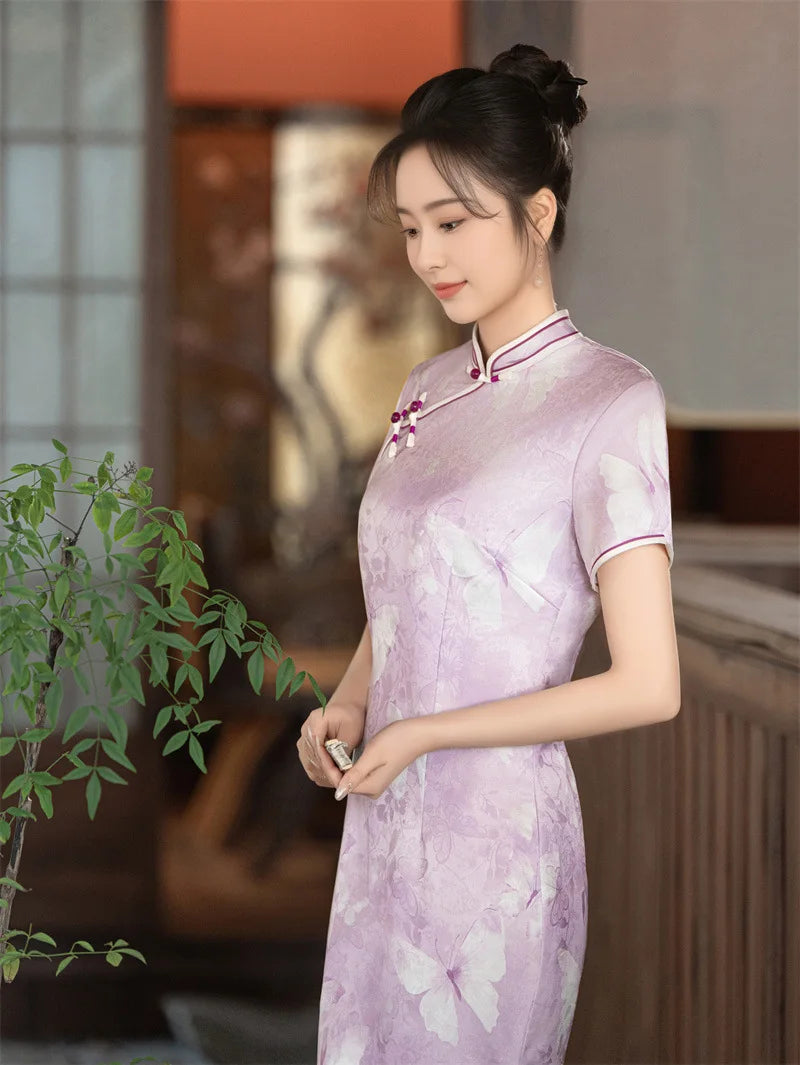 Woman in a light purple traditional Lavender Butterfly Print Midi Qipao Dress  holding a plant indoors.