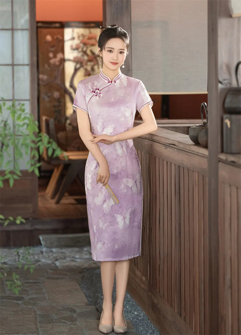 Woman in a traditional light purple Lavender Butterfly Print Midi cheongsam Dress  with floral patterns standing indoors.