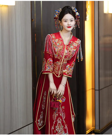 Woman in a traditional red Modern Red Qun Kwa / Xiuhe Chinese Wedding Gown with intricate patterns and accessories.