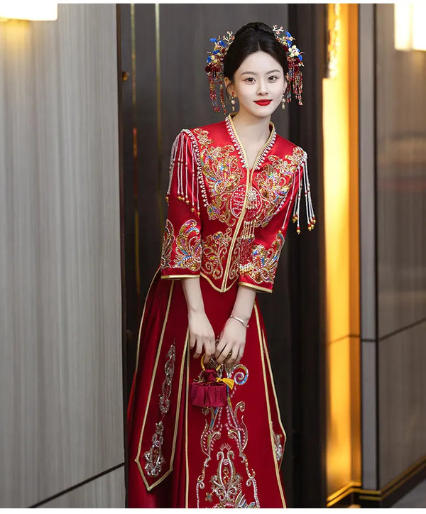 Woman in a traditional red Modern Red Qun Kwa / Xiuhe Chinese Wedding Gown  with intricate patterns and accessories.