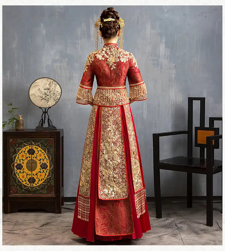 Traditional Red Glittering Qun Kwa Wedding Dress – Traditional Chinese Bridal Attire in a room setting.