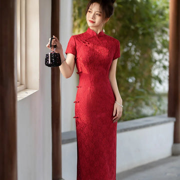 Woman in a Red Lace Midi Length Short Sleeves Chinese Qipao Dress holding a black handbag outdoors.