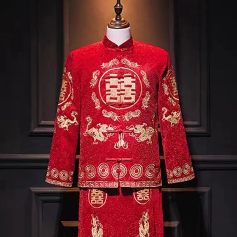 Red traditional Chinese wedding suit with gold embroidery on a mannequin against a dark background