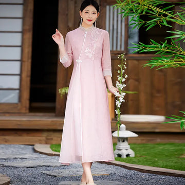 Woman in a Floral Embroidered Loose A line pink Cheongsam Qipao Dress holding flowers outdoors