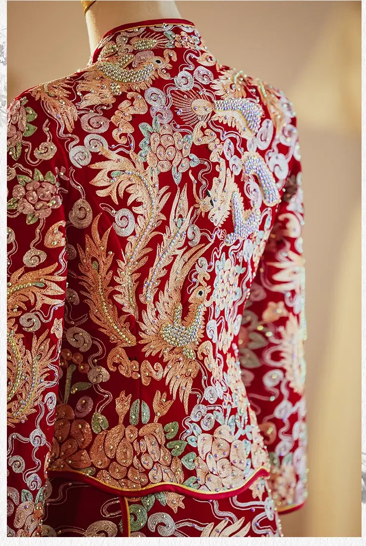 Close-up of intricate gold thread embroidery on a Chinese wedding Qun Kwa jacket