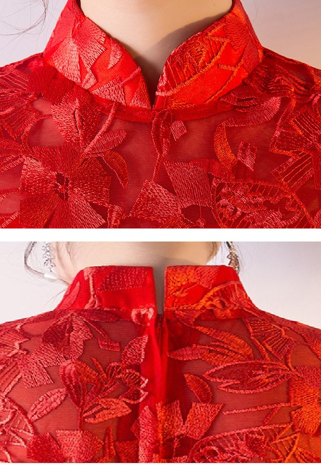 Red lace garment with floral patterns on a plain background
