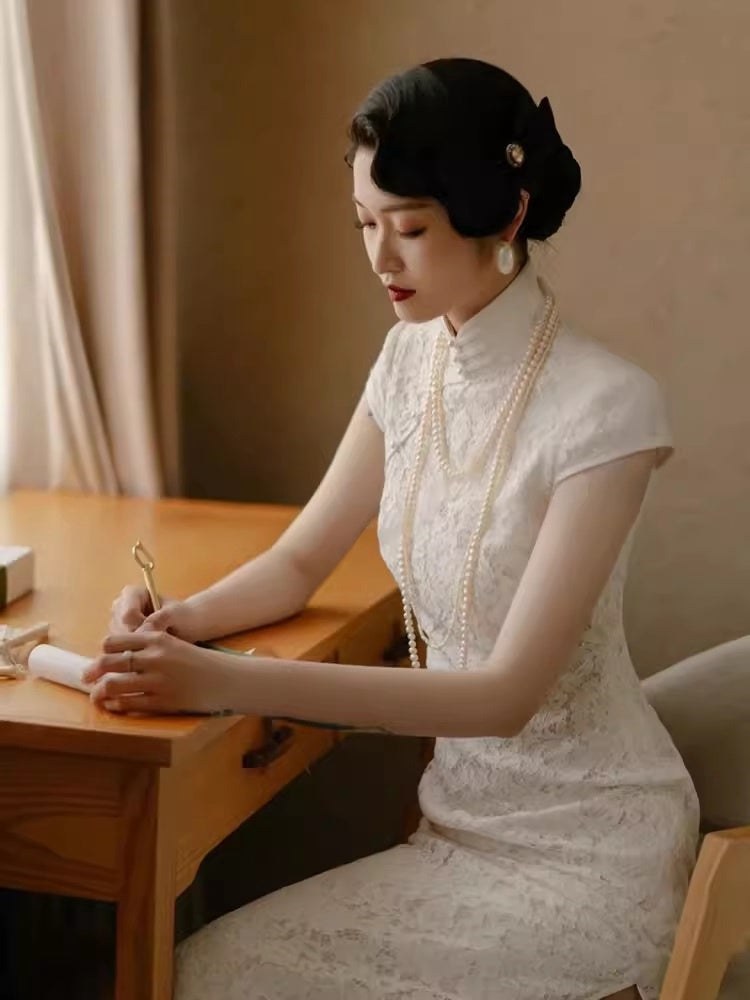 model in traditional chinese white lace cheongsam qipao sitting