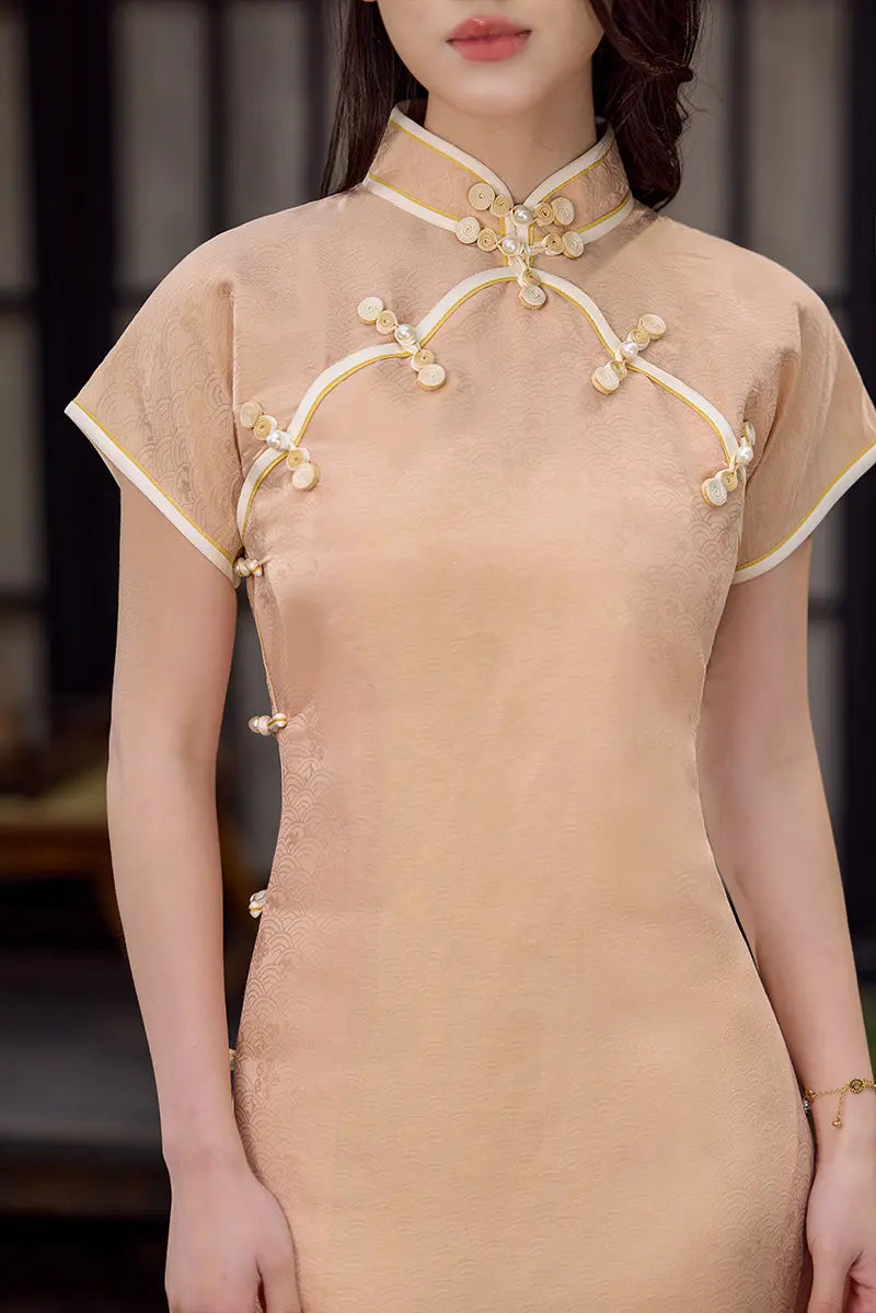 Peach traditional  Song Brocade Full-Opening  Qipao Dress  with gold embroidery on a blurred background