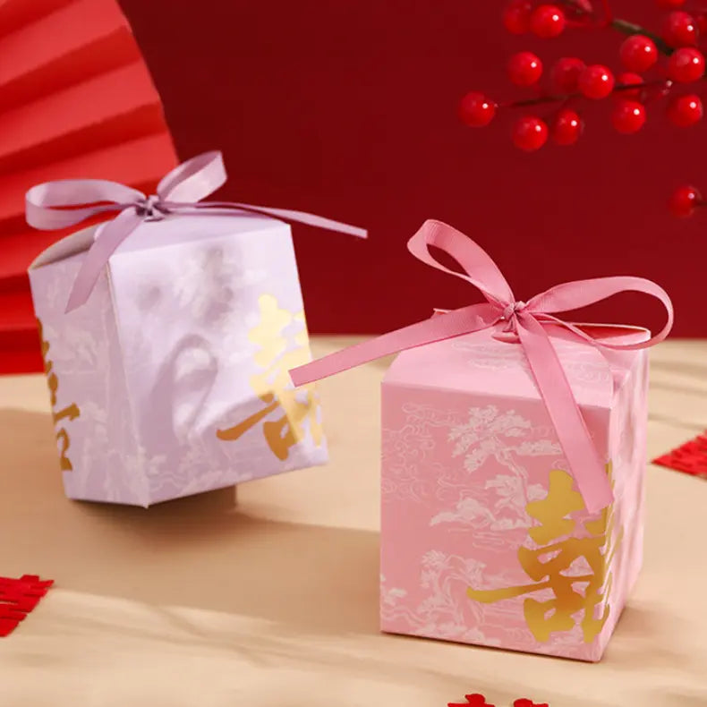 Two Gold Foil Double Happiness Chinoiserie Wedding Favor Boxes   with ribbons on a red background