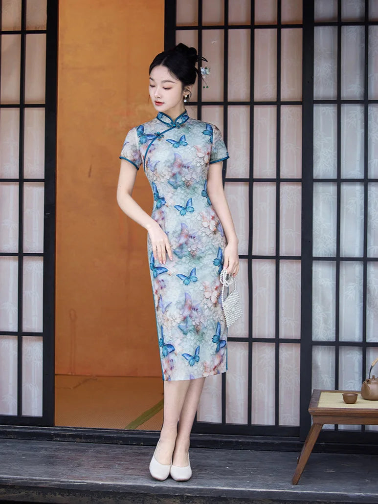 Woman wearing a Blue Midi Length Qipao Dress with Butterfly and Floral Print  with butterfly patterns in a traditional setting.