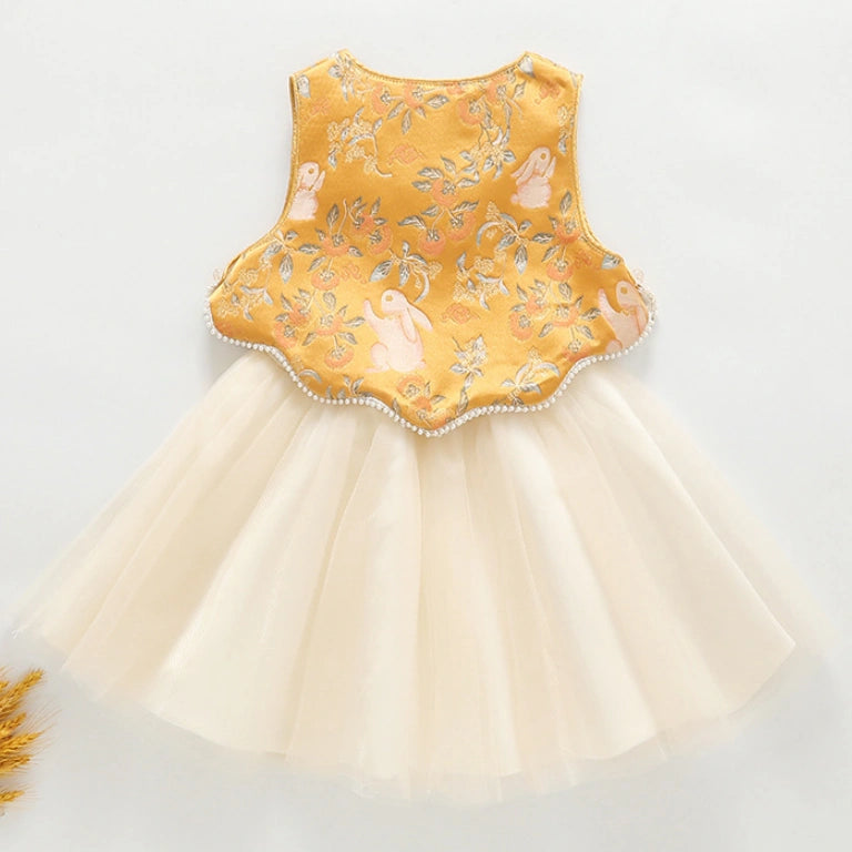 A baby girl's sleeveless  Golden Brocade Vest & Tulle Chinese Baby Princess Dress  featuring a golden yellow embroidered bodice with a scalloped edge and a layered cream tulle skirt, shown on a light gray background.