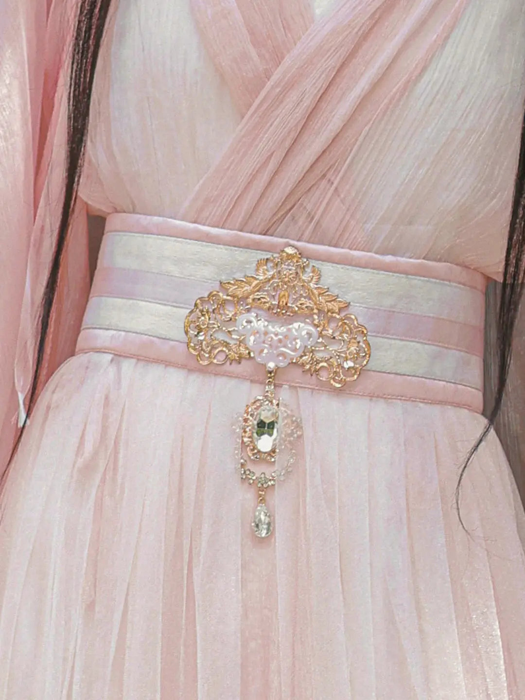 Pink dress with a decorative belt and brooch