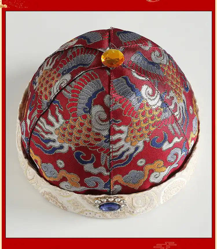 Traditional embroidered hat with intricate designs on a white background