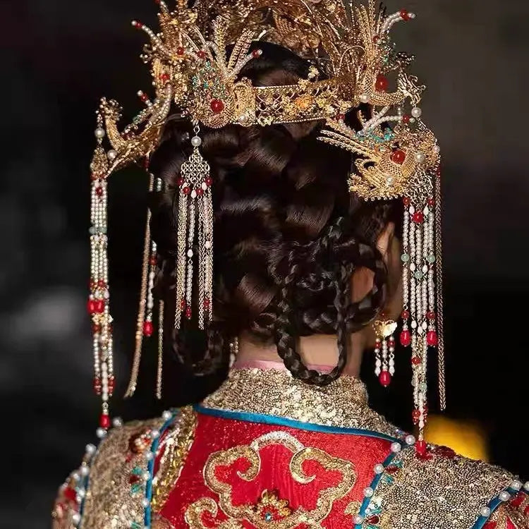 Traditional Chinese headdress with intricate design and jewelry on a dark background