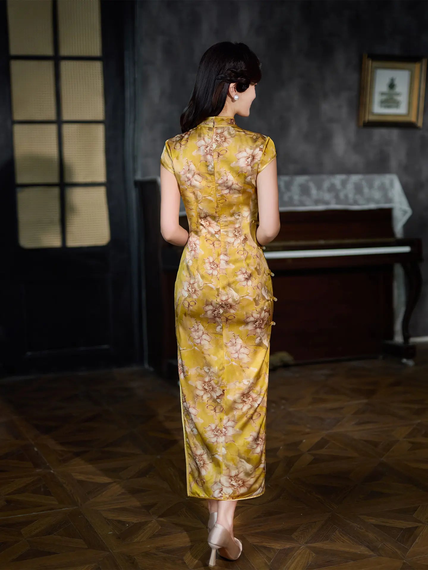 Woman in a yellow floral Vintage Gold Mulberry Silk Chinese Long Qipao Dress  dress standing in a room with a piano.
