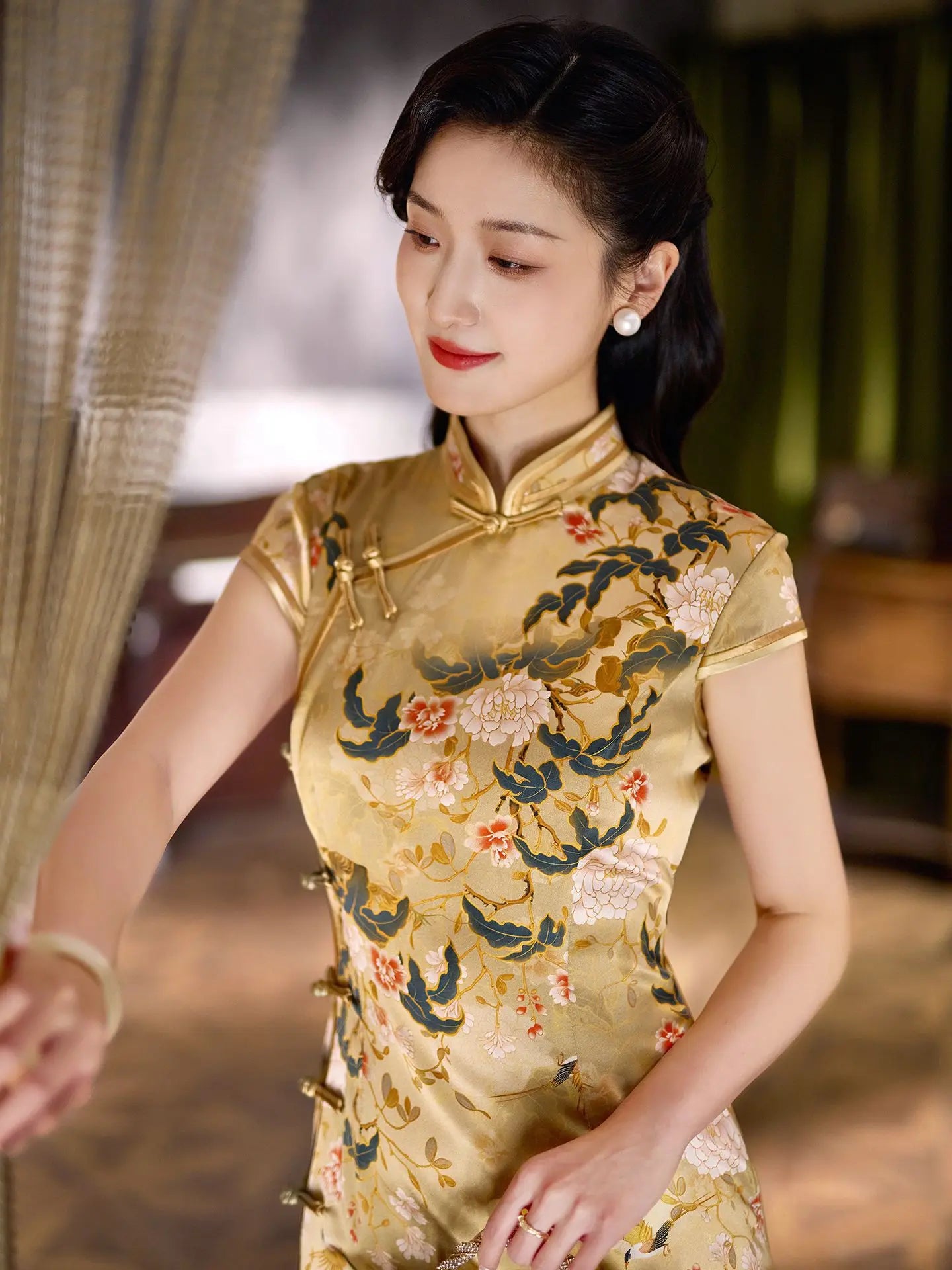 Woman wearing a traditional yellow Vintage Gold Peony Silk Long Qipao Dress with floral patterns.