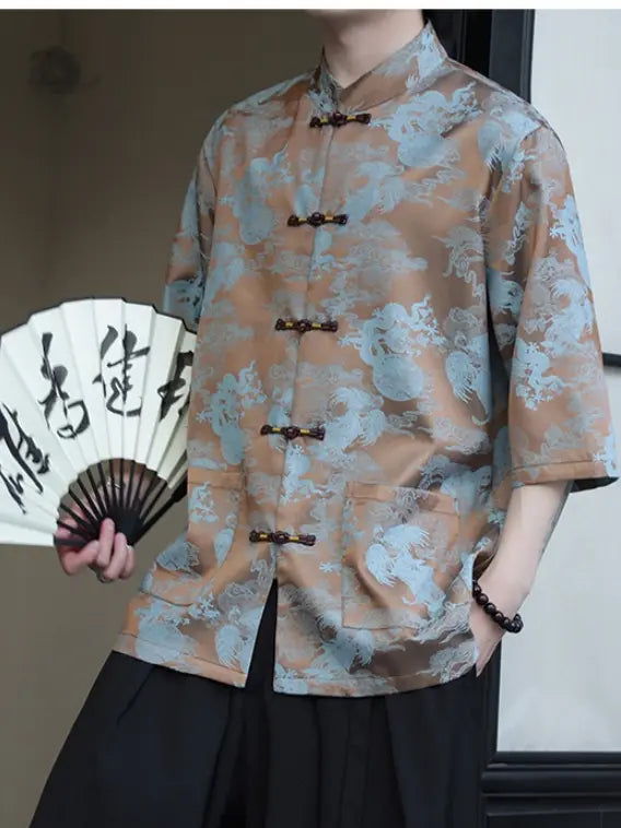 Person wearing a blue Modern Chinese Dragon Print Ice Silk Half Sleeve Tang Shirt holding a fan with calligraphy.