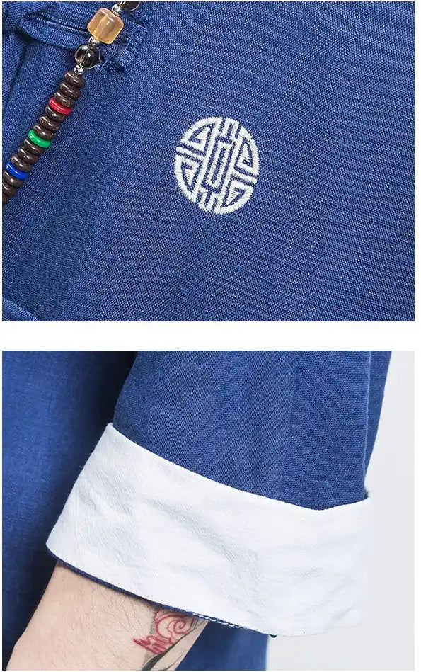 Blue garment with a white embroidered symbol and colorful zipper pull.