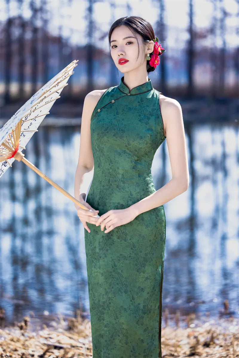 Woman in a green Modern Chinese Mandarin Dress Sleeveless Qipao holding a traditional fan by a body of water.
