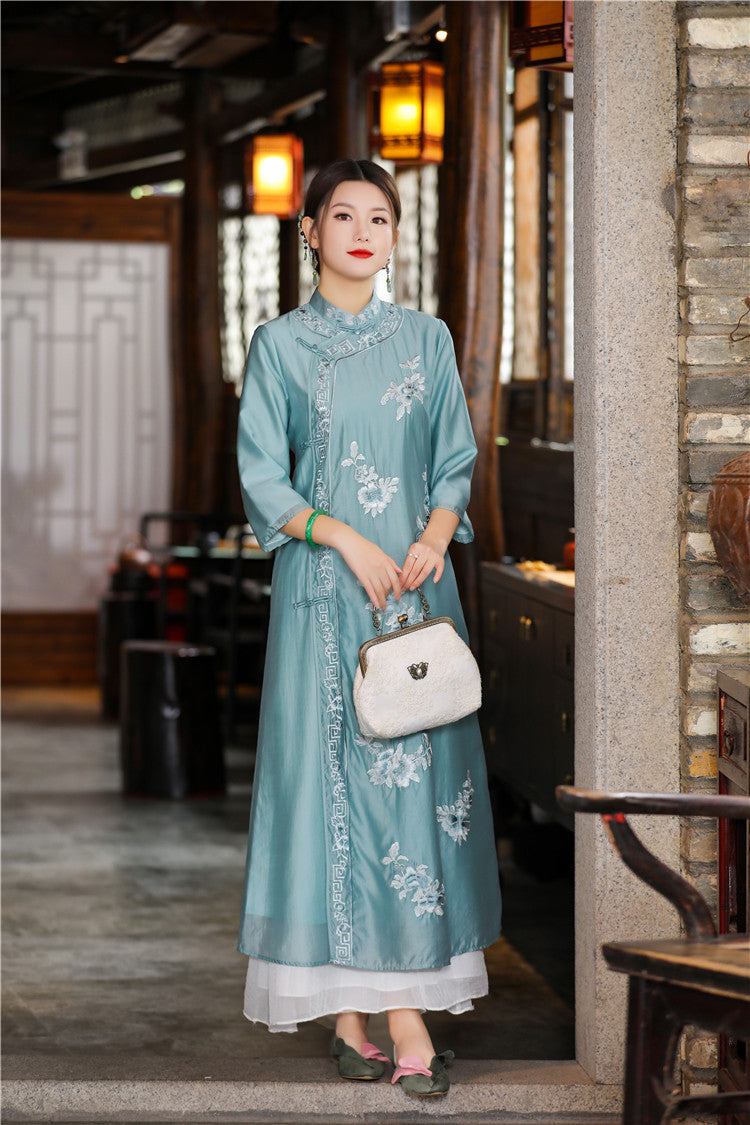 Model in blue floral chinese loose qipao cheongsam dress next to door