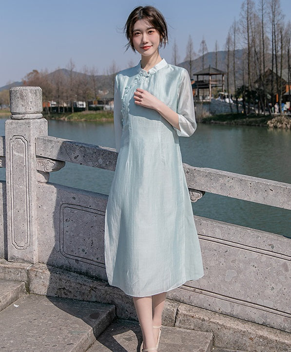 Model in light green loose qipao cheong dress looking straight