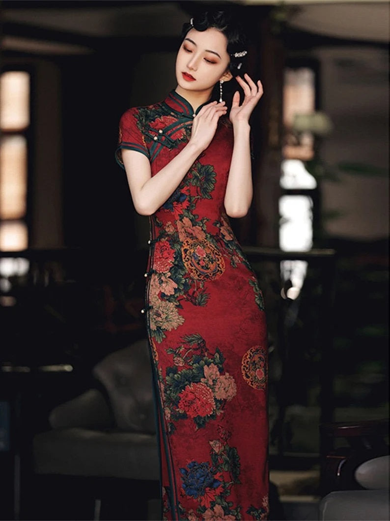 Model in red chinese floral qipao cheongsam dress looking down