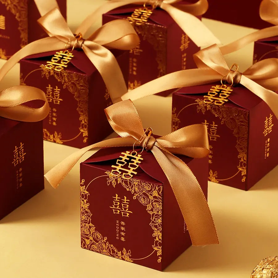 Red & Gold Double Happiness Chinese Wedding Favor gift Boxes  with gold ribbons and decorative elements on a beige background