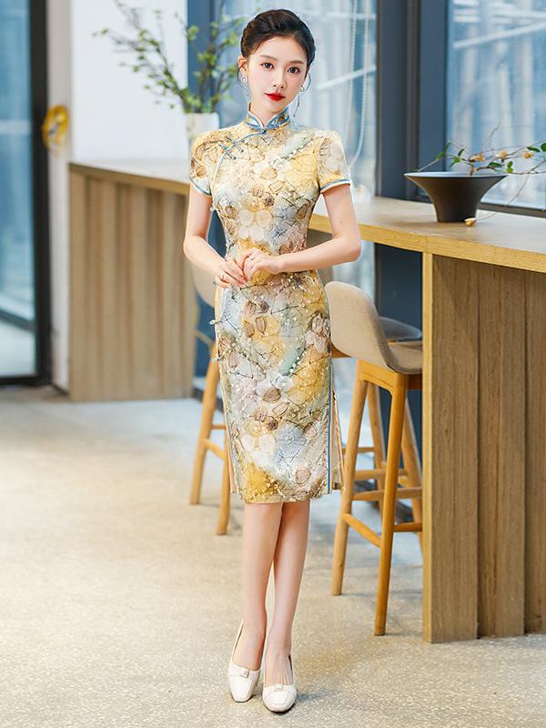 Woman in a Elegant Floral Mulberry Silk knee length Qipao Cheongsam Dress  standing in a modern indoor setting with wooden furniture and plants.