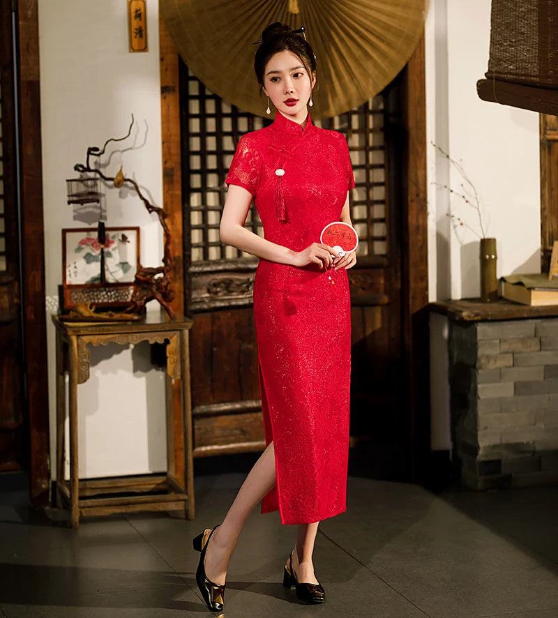 Woman in a Red Lace Midi Length Short Sleeves Qi pao Dress  holding a small round object in a traditional setting
