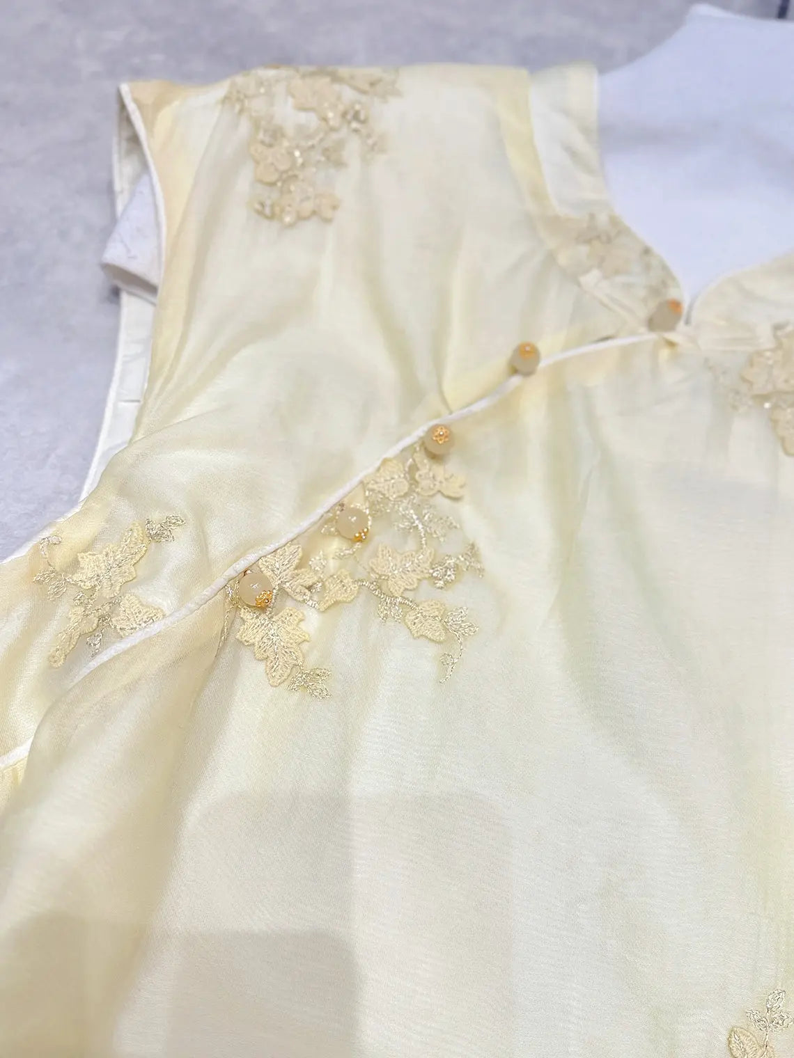 yellow New Chinese Style - Sleeveless Asymmetric Top & Maxi Skirt Set dress with gold floral embroidery on a light gray background