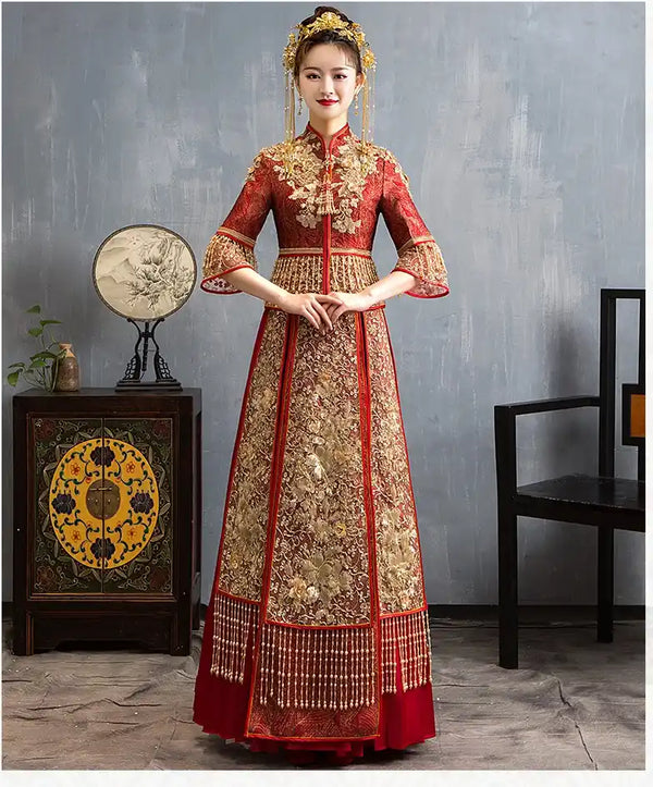 Woman in Red Glittering Qun Kwa Wedding Dress – Traditional Chinese Bridal Attire standing in a room with decorative elements.