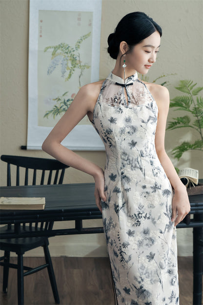 model in black white floral halter neck midi cheongsam qipao dress looking down