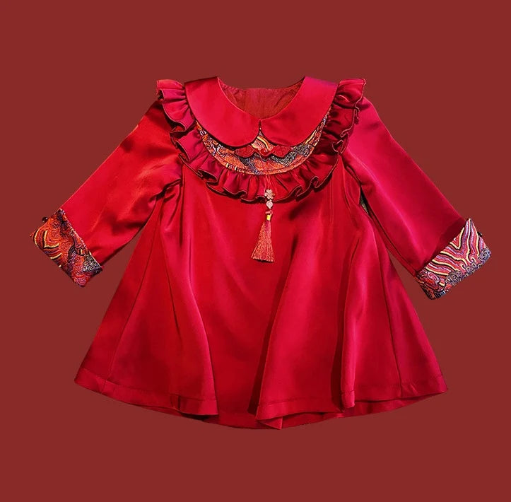 Red Modern Chinese Baby Qipao Cheongsam Dress with Tassel with decorative neckline and sleeves on a brown background