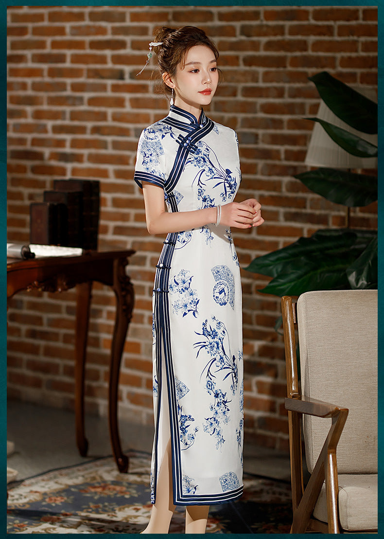 Model in Blue white floral qipao dress standing looking right