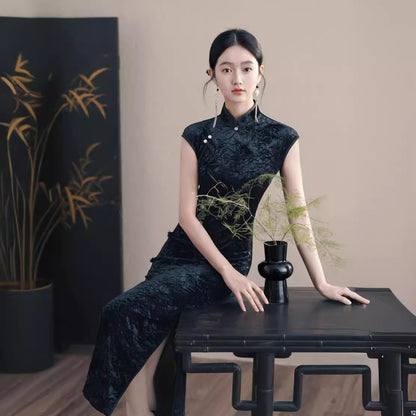 Model in black velvet sleeveless qipao cheong dress sitting