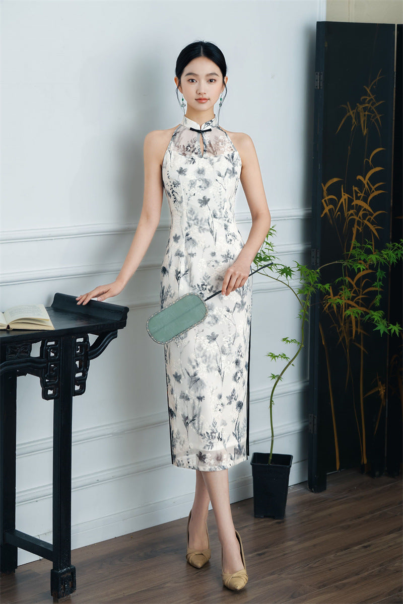 model in black white floral halter neck midi cheongsam qipao dress with hand fan