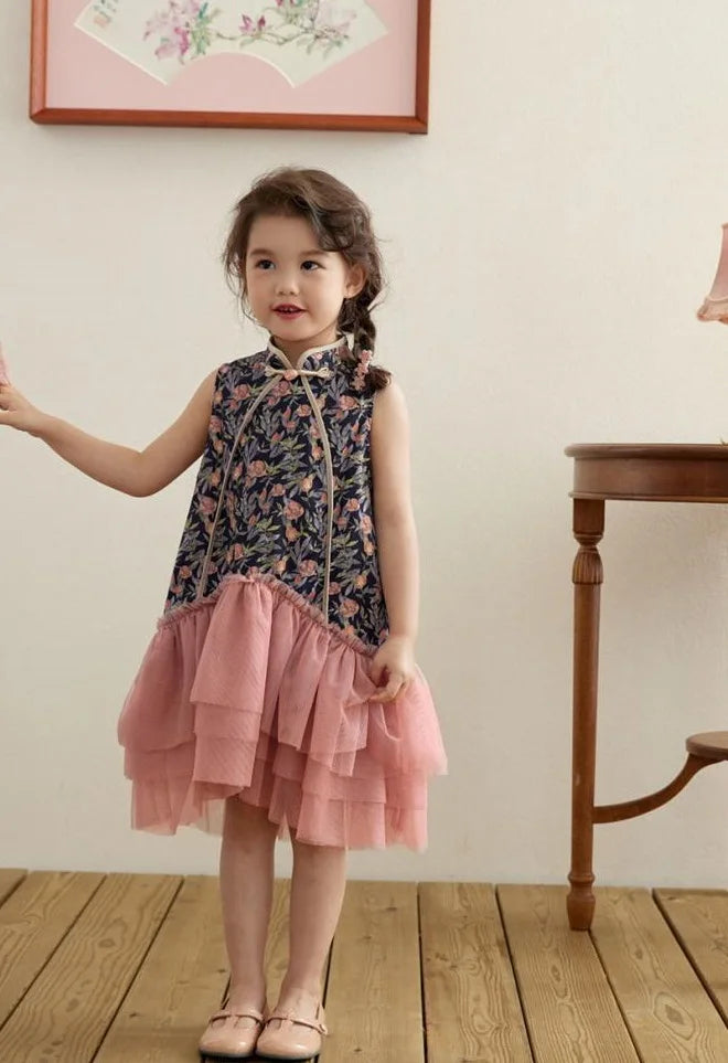 Young girl in a Modern Pink Floral Tulle Qipao Dress standing in a room with wooden floor and wall art.