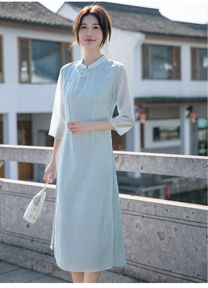 Model in light green loose qipao cheong dress on a bridge