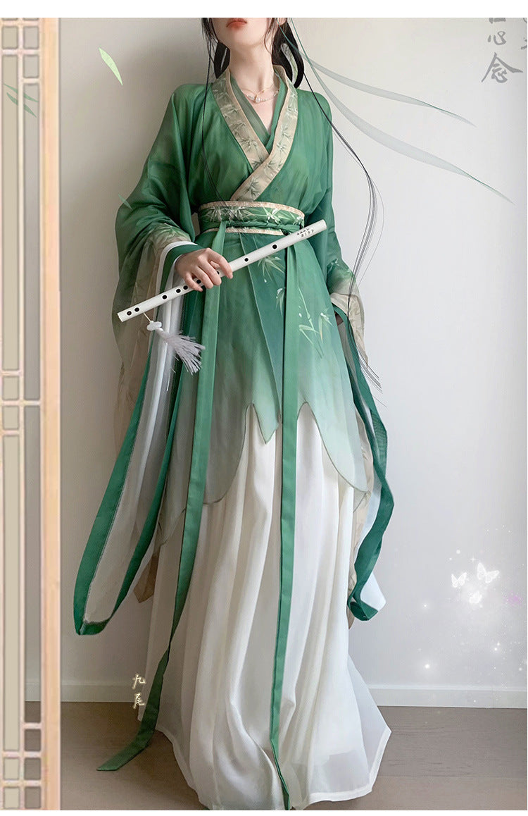 model in green bamboo leaves print hanfu with flute