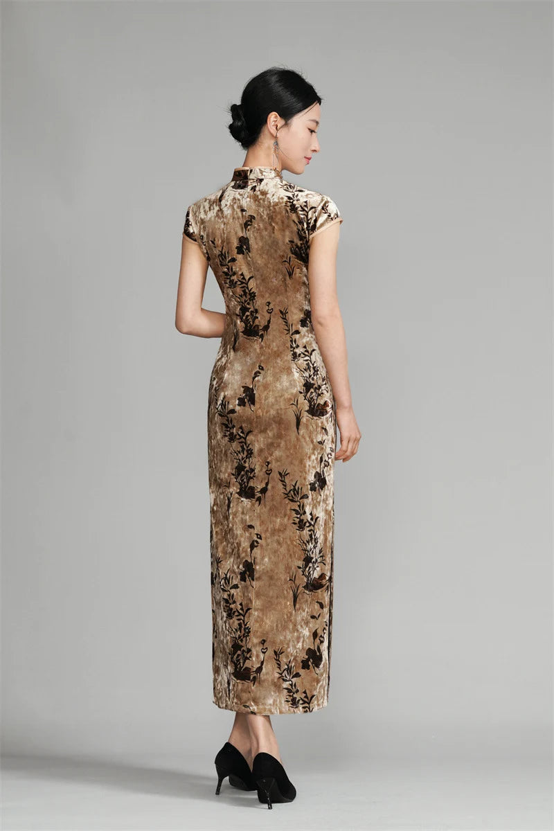Woman wearing a long, Golden Floral Velvet Qipao Cheongsam Dressagainst a gray background