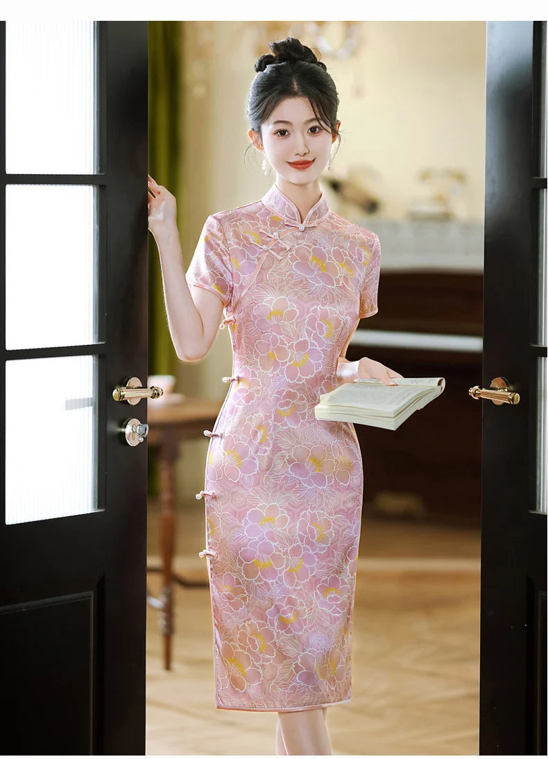 Woman in a traditional Pink Floral Mullbury Silk Short Sleeves Qipao Dress  standing in a room with a blurred background